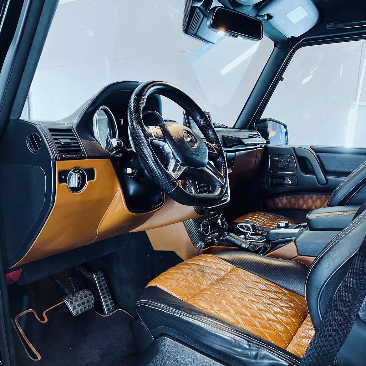 Tan quilted leather interior of a Mercedes G-Wagon after restoration
